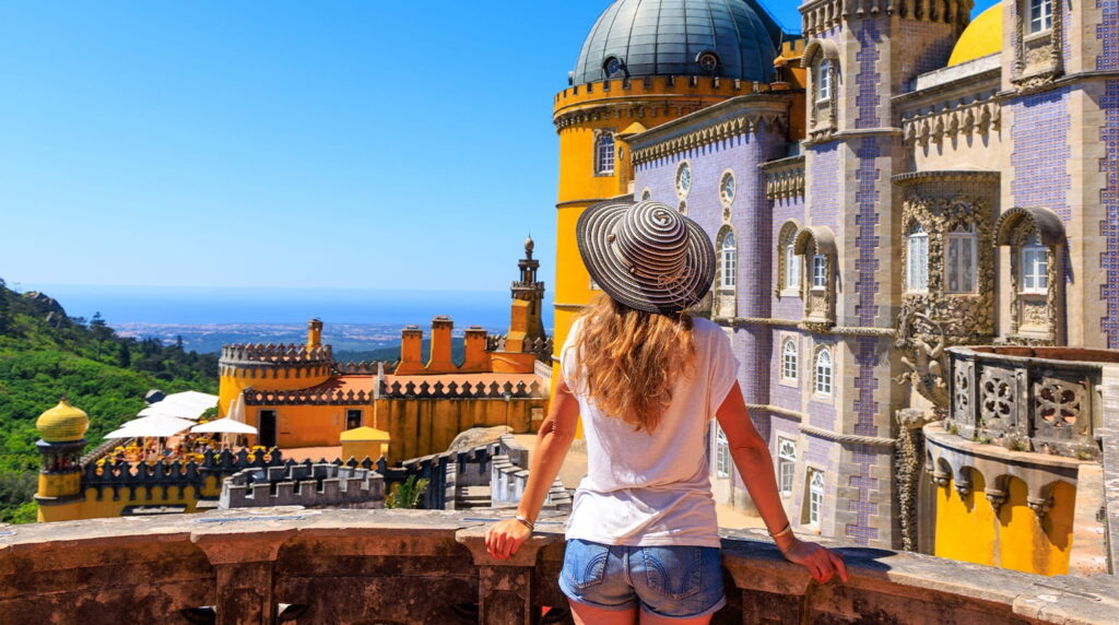 tourist enjoying view of Pena castle, lisbon, portugal - Best Spring Break Destinations for College Students