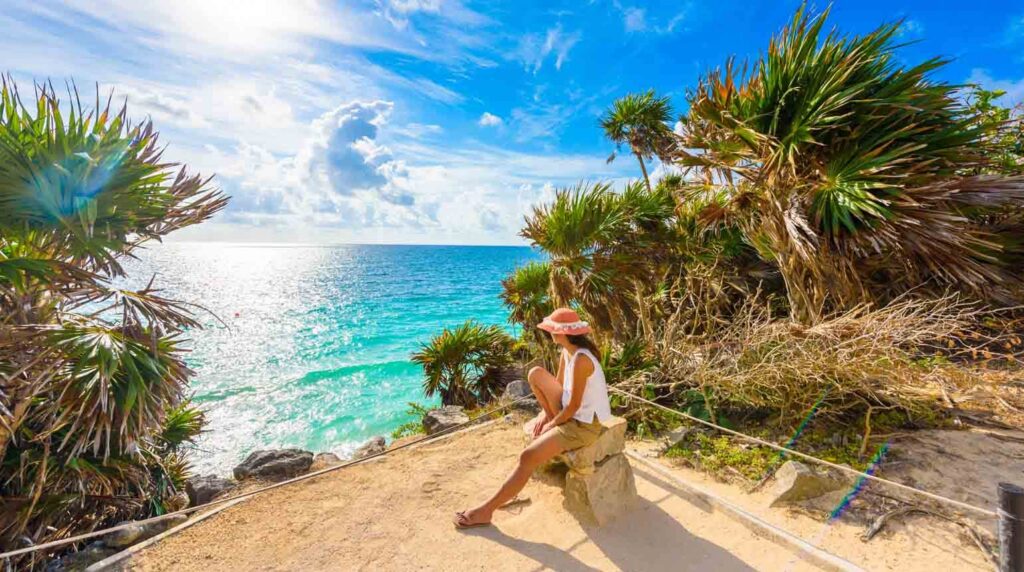 The image appears to show a scenic coastal viewpoint at the Tulum Archaeological Site