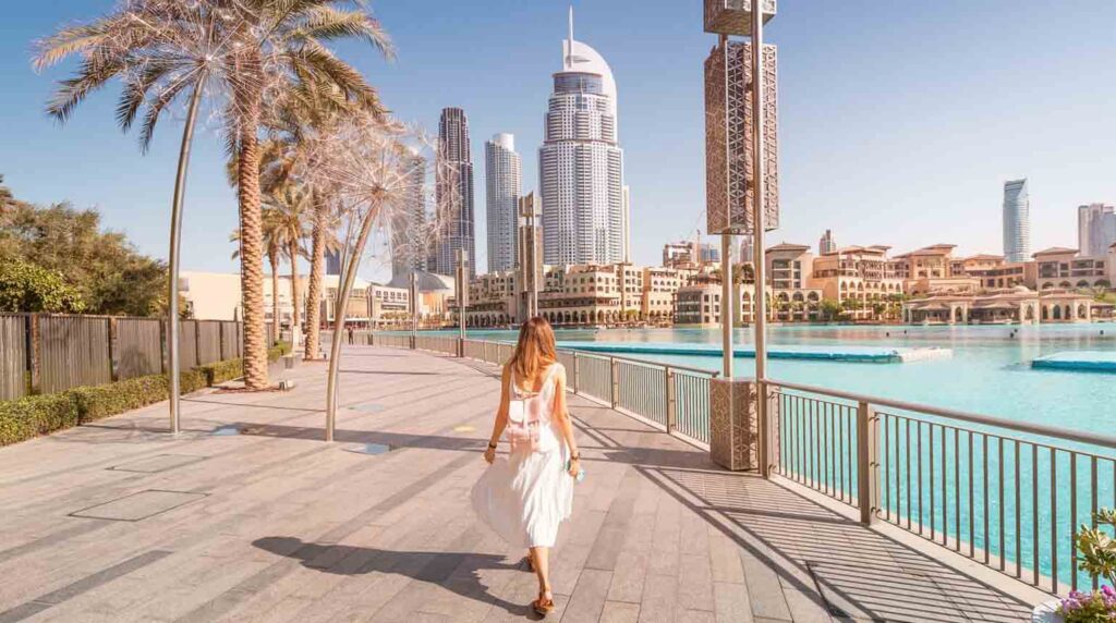 person walking along the waterfront promenade in Downtown Dubai
