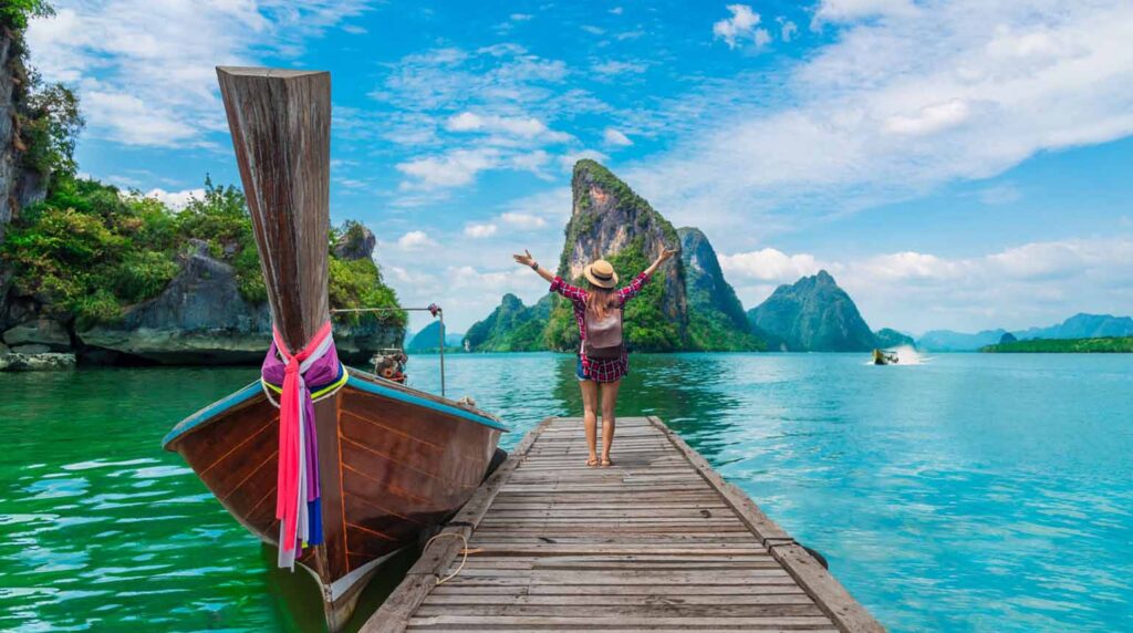 wooden pier and a traditional longtail boat in Phang Nga Bay, Phuket.