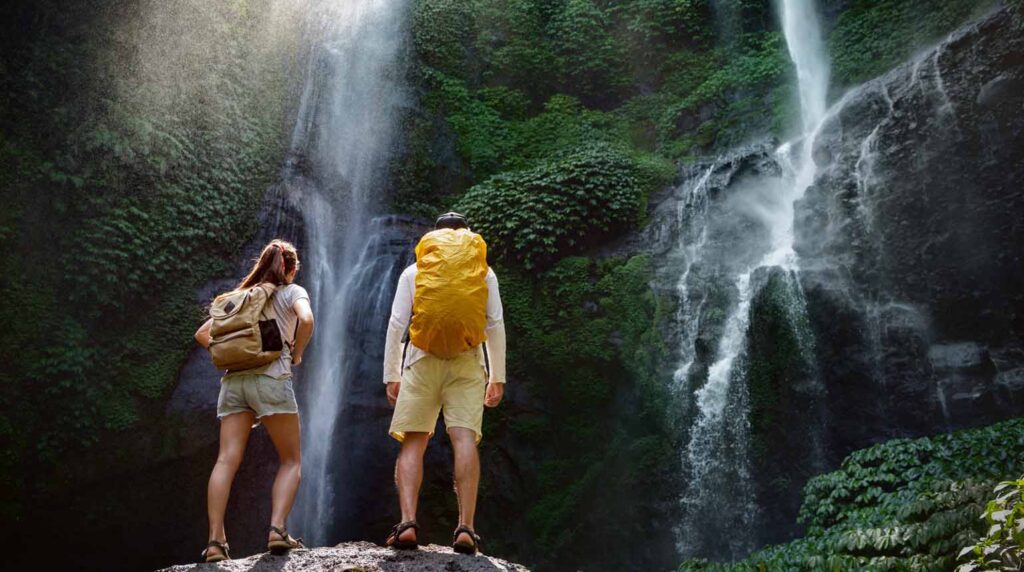 This breathtaking image shows a couple looking at the majestic Sekumpul Waterfall